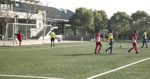 High School Soccer Players Preparing for a Free Kick in Sunny Field