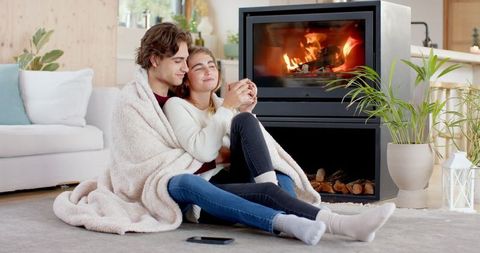 Cozy embrace by fire: intimate moment in modern living room