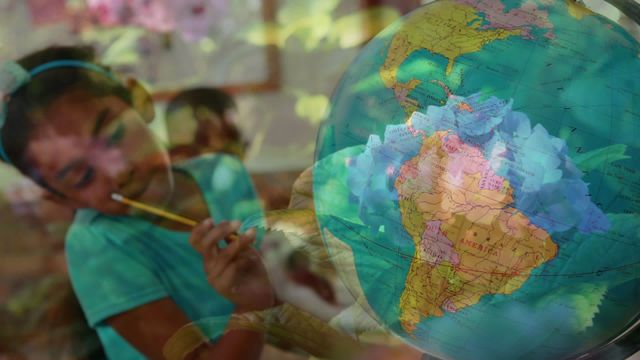 A young schoolgirl learning geography gazes thoughtfully at a globe in a dreamy, creatively composed scene enriched with the overlay of vibrant green leaves. This imaginative and inspiriting image beautifully combines themes of education and nature, suggesting opportunities for adventurous learning and environmental studies. Perfect for use in educational materials, websites promoting global education, and advertising related to eco-friendly initiatives aimed at children.