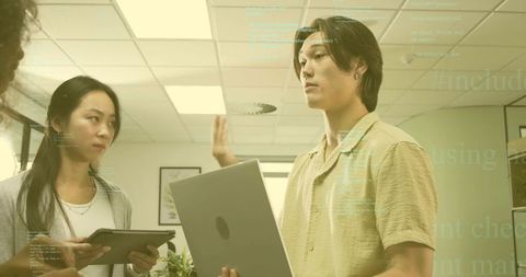 Modern office team discussing tech projects with digital devices