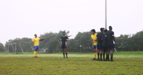 Soccer Players Preparing Free Kick in Intense Match