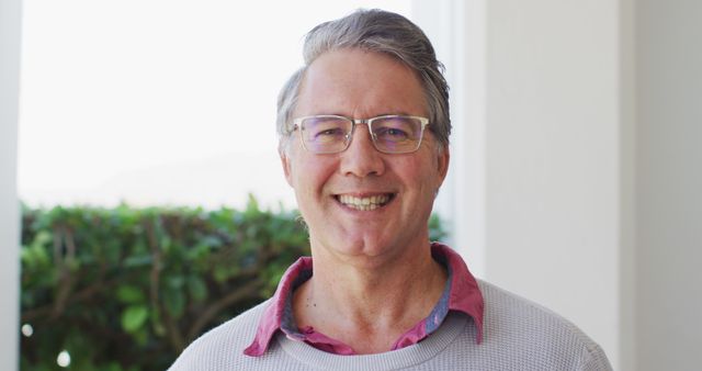 Image portrait of happy senior caucasian man in glasses smiling to camera at home. Retirement, domestic life, health and happiness concept digitally generated image.