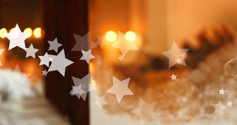 Falling Stars Overlaying Warm Christmas Candle Glow