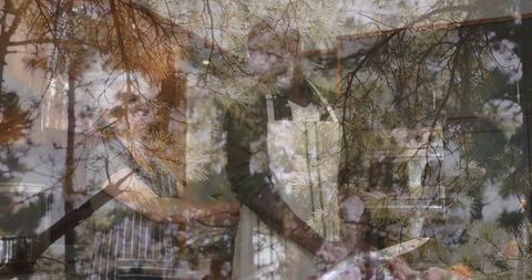 Couple cooking together with pine double exposure in sunlit rustic kitchen wearing aprons