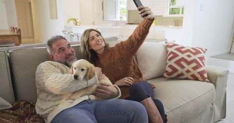 Couple with Puppy Snap Selfie in Cozy Modern Living Room
