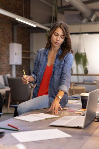 Female designer reviewing color swatches in modern industrial office