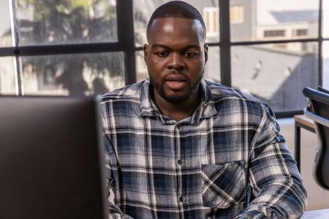Professional Man in Office Using Computer for Productivity