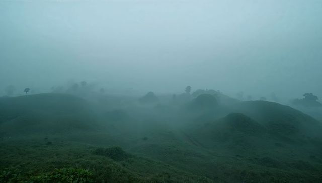 Fog Shrouding Moody Hills in Serene Moorland Landscape