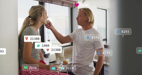 Playful Couple Enjoying Breakfast in Modern Kitchen