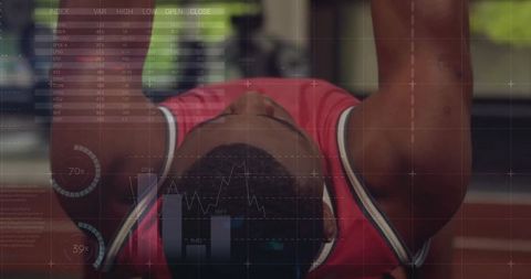 Male athlete performing bench press in gym with futuristic fitness hud overlay