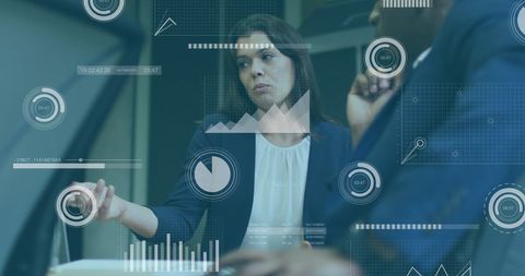 Diverse Business Professionals Discussing Data with Interface Graphics