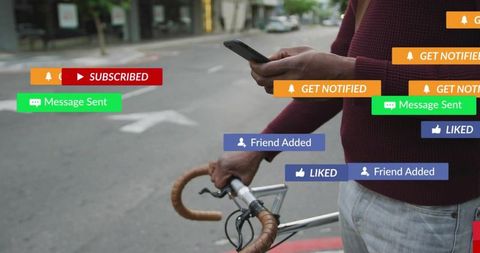 Urban cyclist checking phone while holding bicycle surrounded by social media notifications