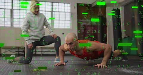 Bald male doing low push-up with coach observing in gym with binary overlay