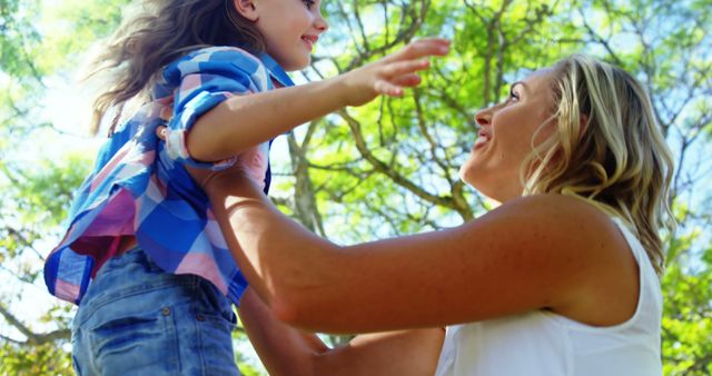 Mother Holding Smiling Daughter Outdoors - Download Free Stock Images Pikwizard.com