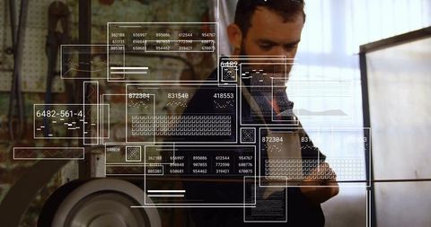 Technician analyzing digital panels in industrial workshop