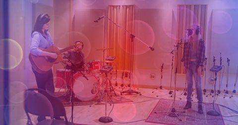 Musicians Recording Song in Studio with Instruments and Headphones