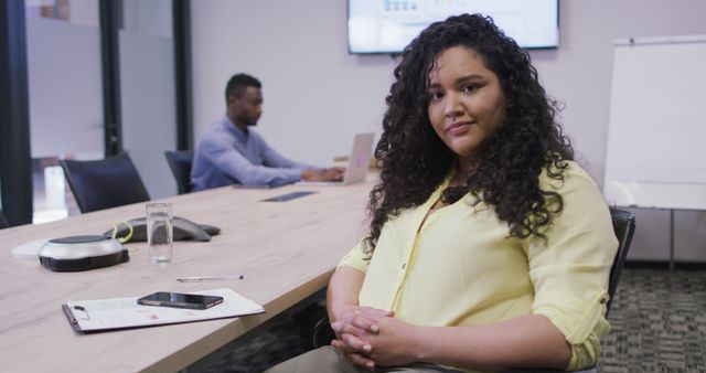 Portrait of smiling biracial businesswoman looking at camera in modern office. business and office workplace.