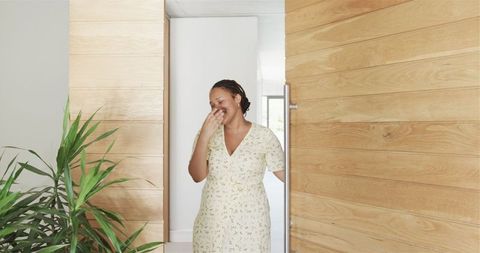 Cheerful Young Woman Opening Door in Modern Home Interior - Download Free Stock Images Pikwizard.com