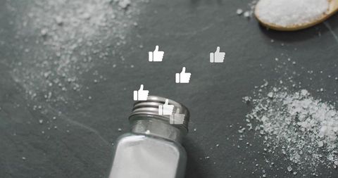 Salt Shaker Spilling on Table with Thumbs-Up Symbols