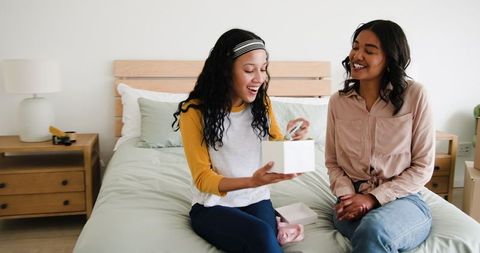 Happy Mother and Daughter Sharing a Special Moment with a Gift