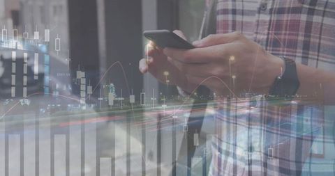 Man holding smartphone viewing market charts with night light trails and stock graphs