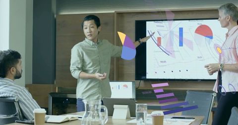 Multiracial Team Discussing Data Visualization in Modern Office