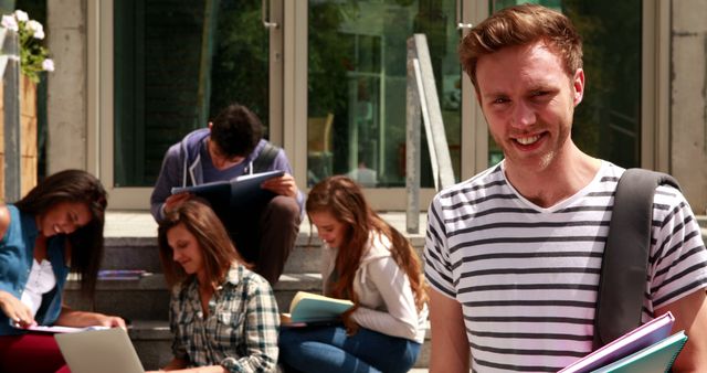 Smiling Student in Front of Group Studying on School Steps - Download Free Stock Images Pikwizard.com