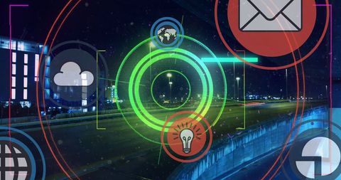 Futuristic digital icons over cityscape at night