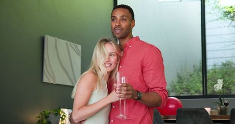 Couple Celebrating with Champagne at Home Gathering
