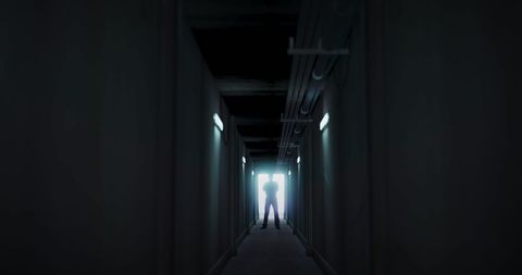 Silhouette Man Standing in Dark Corridor Illuminated by Light - Download Free Stock Images Pikwizard.com