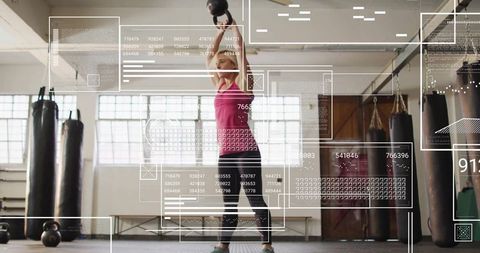 Woman Lift Kettlebell in Gym Amidst Digital Data