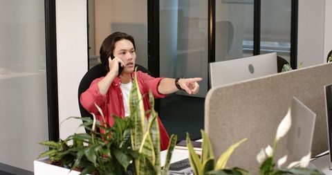 Professional in Modern Office with Smartphone Communication