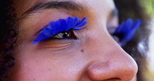 Close-up of Woman with Vibrant Blue Feather Eyelashes - Download Free Stock Images Pikwizard.com