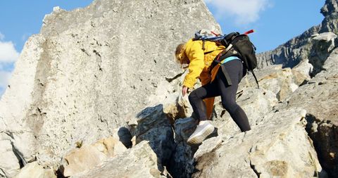 Caucasian Woman Climbing Rocky Mountain for Adventure and Thrill - Download Free Stock Images Pikwizard.com
