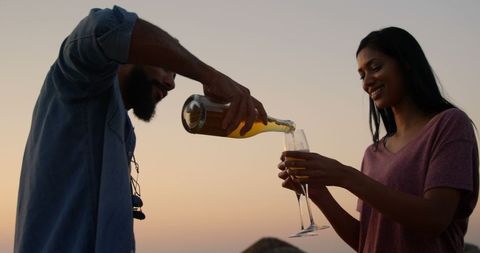 Couple Enjoying Sunset Wine Celebration Outdoors