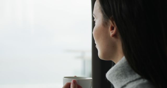 Woman Relaxing by Large Window with Cup of Coffee - Download Free Stock Images Pikwizard.com