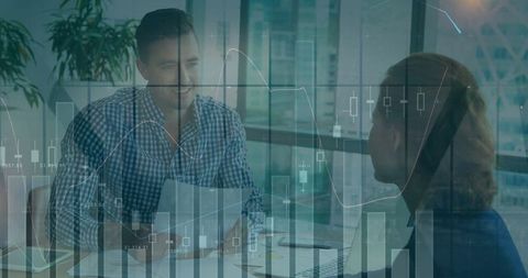 Business professionals discussing charts in modern office setting