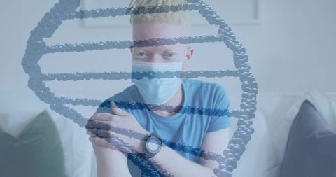Masked man holding arm after vaccination with dna helix overlay for medical concept