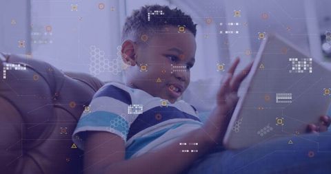 Boy Using Tablet at Home with Digital Overlay for Modern Technology Theme