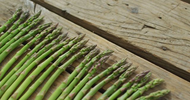 Image of fresh asparagus stalks on wooden background. fusion food, fresh vegetables and healthy eating concept.