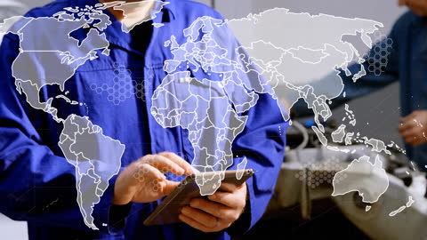 Male Mechanic Using Tablet with World Map Overlay
