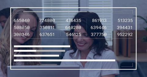 Smiling colleagues leaning over laptop with HUD analytics overlay showing data dashboard