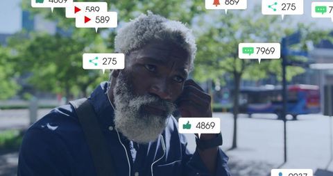 Urban professional listening with earbuds while receiving social media notifications