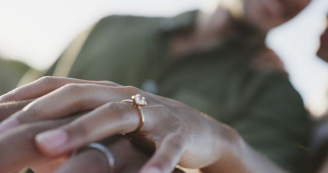 Close up of biracial couple holding hands with rings at wedding on beach. Love, wedding, ceremony, summer and lifestyle, unaltered.