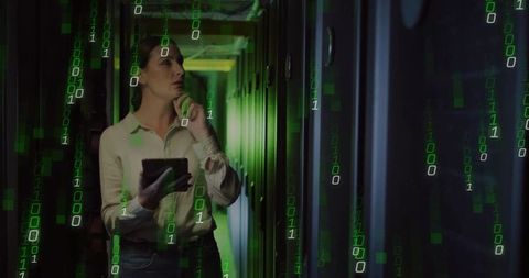 Female Technician Analyzing Data Streams in Server Room