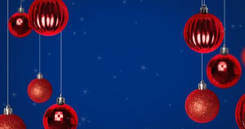 Festive Red Christmas Baubles on Sparkling Blue Background
