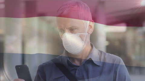 Concerned Man in Face Mask Checking Smartphone With Superimposed Flag
