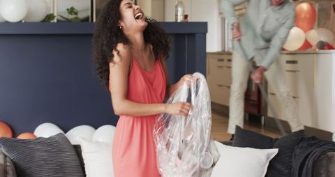 Joyful Couple Tidying Post-Party Living Room