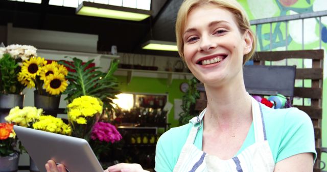 Smiling Female Florist Holding Tablet - Download Free Stock Images Pikwizard.com