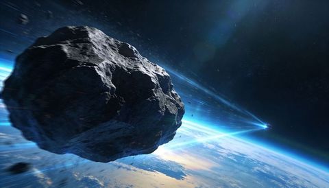 Drifting giant asteroid skimming blue planet horizon with blazing light trails and debris